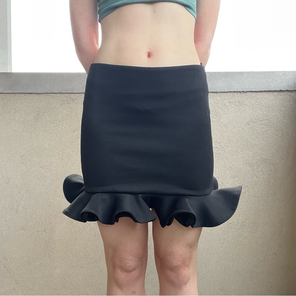 Black ruffle mini skirt.